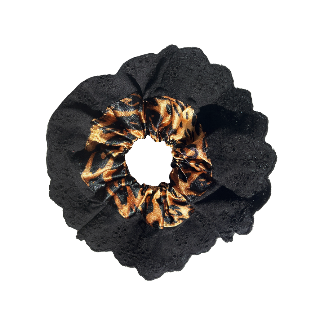 Meet LOLA!  A scrunchie big enough to hold all hair. Two layers of broderie anglaise makes it perfect for an all up look on both fine and thicker hair, or great for securing a bun. The silky centre is kinder to the hair, especially if being worn overnight.  Each scrunchie comes with a pink ribbon tag on which can be used as a gift tag.  Size: approx 18cm  Colour: black lace with a classic leopard print silk centre  Material: Cotton and Satin