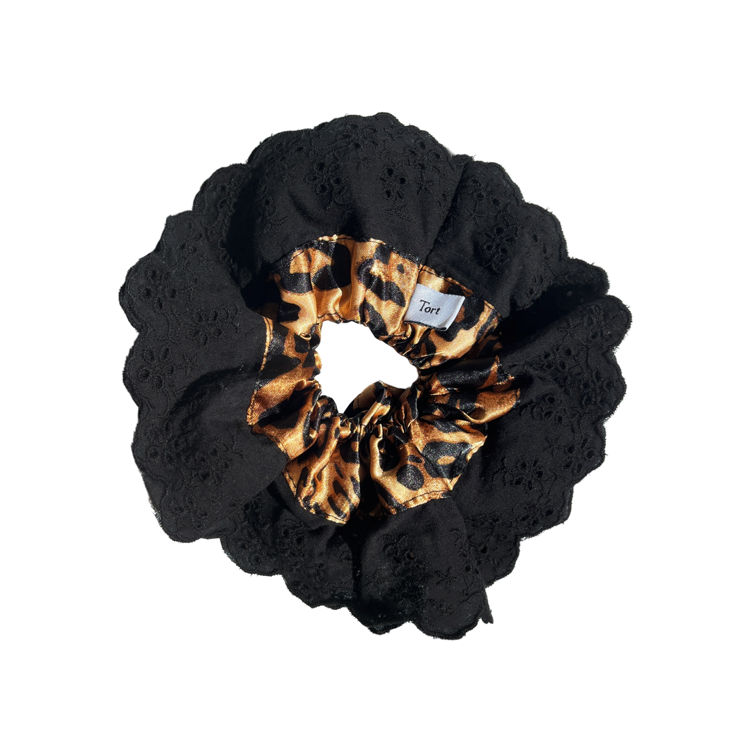 Meet LOLA!  A scrunchie big enough to hold all hair. Two layers of broderie anglaise makes it perfect for an all up look on both fine and thicker hair, or great for securing a bun. The silky centre is kinder to the hair, especially if being worn overnight.  Each scrunchie comes with a pink ribbon tag on which can be used as a gift tag.  Size: approx 18cm  Colour: black lace with a classic leopard print silk centre  Material: Cotton and Satin