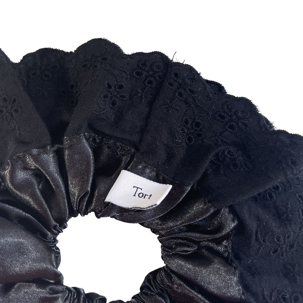 Meet LOLA!  A scrunchie big enough to hold all hair. Two layers of broderie anglaise makes it perfect for an all up look on both fine and thicker hair, or great for securing a bun. The silky centre is kinder to the hair, especially if being worn overnight.  Each scrunchie comes with a pink ribbon tag on which can be used as a gift tag.  Size: approx 18cm  Colour: black lace with a black silk centre  Material: Cotton and Satin