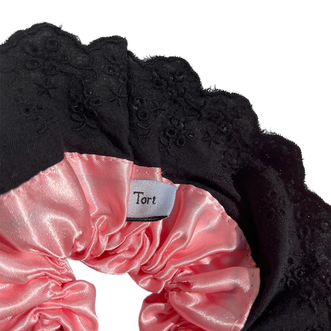 Meet LOLA!  A scrunchie big enough to hold all hair. Two layers of broderie anglaise makes it perfect for an all up look on both fine and thicker hair, or great for securing a bun. The silky centre is kinder to the hair, especially if being worn overnight.  Each scrunchie comes with a pink ribbon tag on which can be used as a gift tag.  Size: approx 18cm  Colour: black lace with a blush pink silk centre  Material: Cotton and Satin