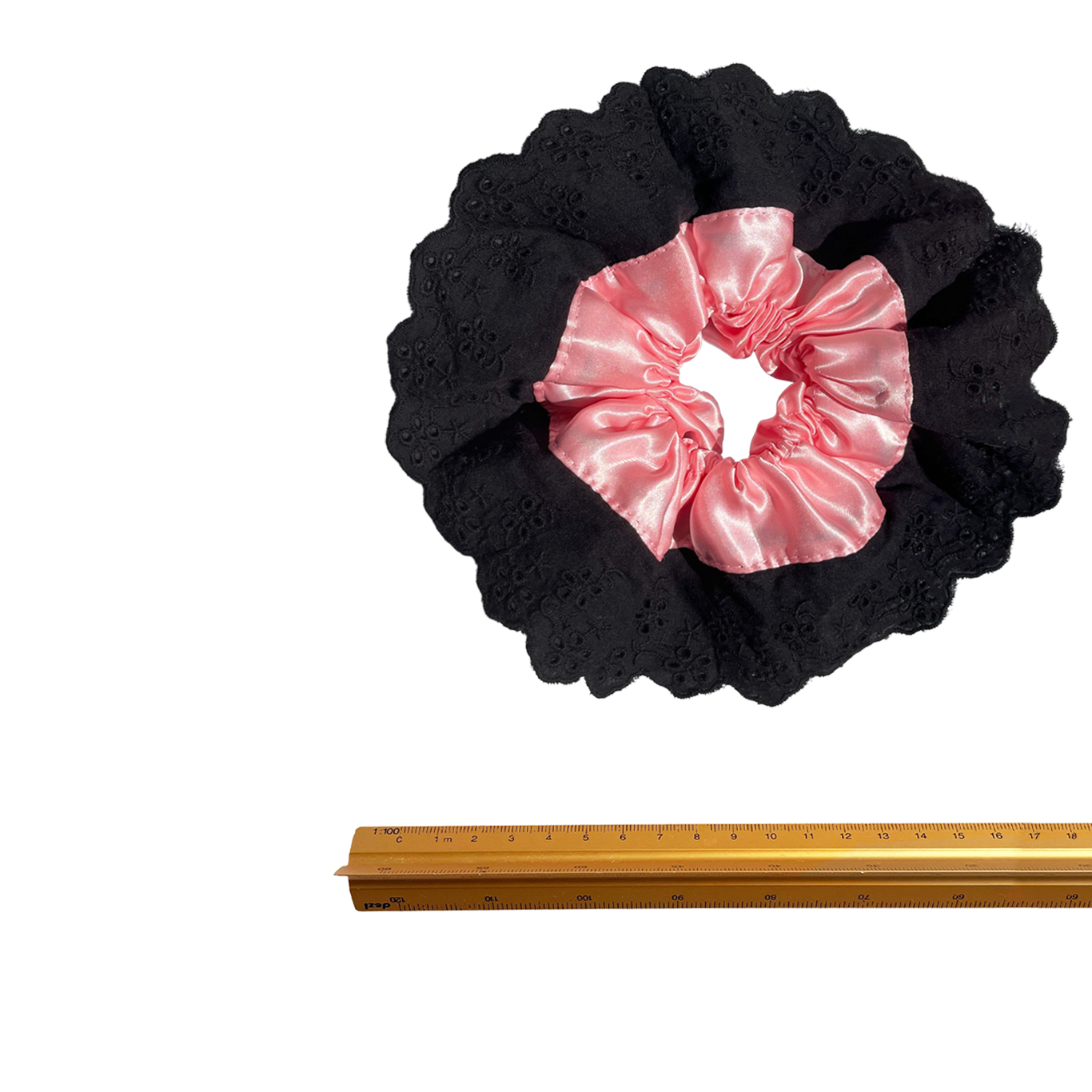Meet LOLA!  A scrunchie big enough to hold all hair. Two layers of broderie anglaise makes it perfect for an all up look on both fine and thicker hair, or great for securing a bun. The silky centre is kinder to the hair, especially if being worn overnight.  Each scrunchie comes with a pink ribbon tag on which can be used as a gift tag.  Size: approx 18cm  Colour: black lace with a blush pink silk centre  Material: Cotton and Satin