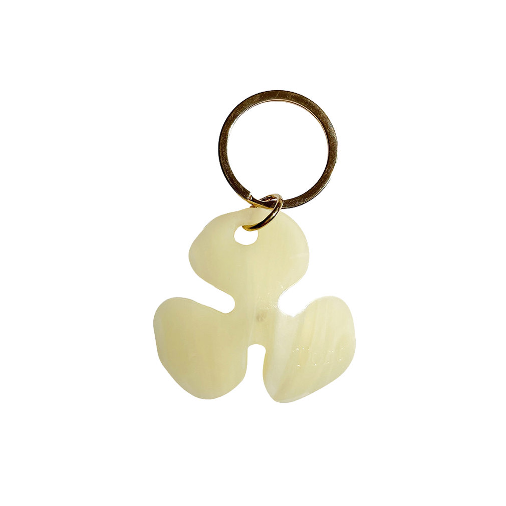 Meet FLOR!  A bleached lemon yellow flower with an orange jewel in the centre and Tort logo embossed on the back. Complete with brass-gold keyring hardware so you're able to attach to keys.  Each keyring comes in a branded Tort pouch (colours change seasonally).  Size: 4.5cm  Colour: bleached lemon yellow with orange jewel  Material: eco-resin