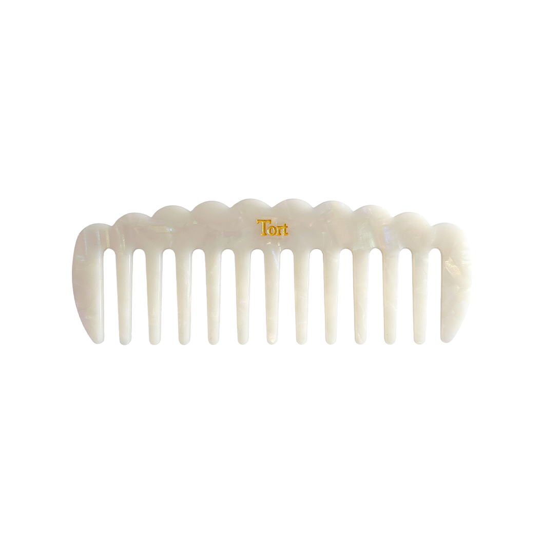 Meet LUCY!  A sturdy scallop edged comb make from eco-resin. Designed with widely positioned rounded teeth so that hair retains texture and strength. Glides through wet or dry hair to gently untangle or tease after curling with tongs or straighteners, while preventing breakage, split ends and frizz. Great for curly hair.  Each comb comes in a branded Tort pouch (colours change seasonally).  Size: 15cm  Colour: marbled pearlescent white  Material: eco-resin  Combs are non-refundable for hygiene reasons.