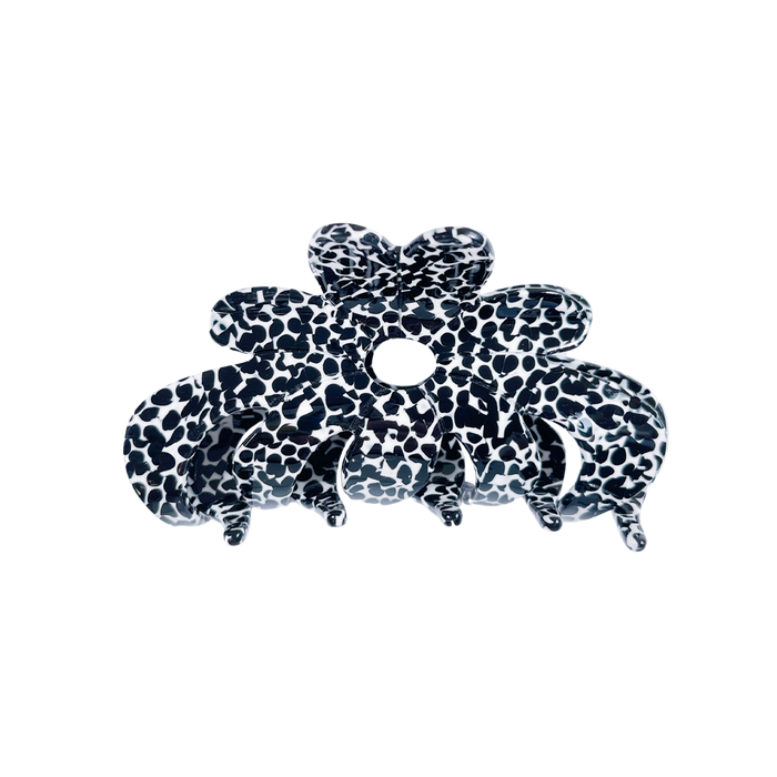Meet AMMA!  A floral shaped medium size claw. The medium size makes it very easy to use. For medium thickness/length it can be used for an all up look and for finer and thick hair, it will probably be best styled securing a bun or a half up style.  Each clip comes in a branded Tort pouch (colours change seasonally).  Size: 9.5cm  Colour: black and white Dalmatian-like pattern  Material: eco-resin