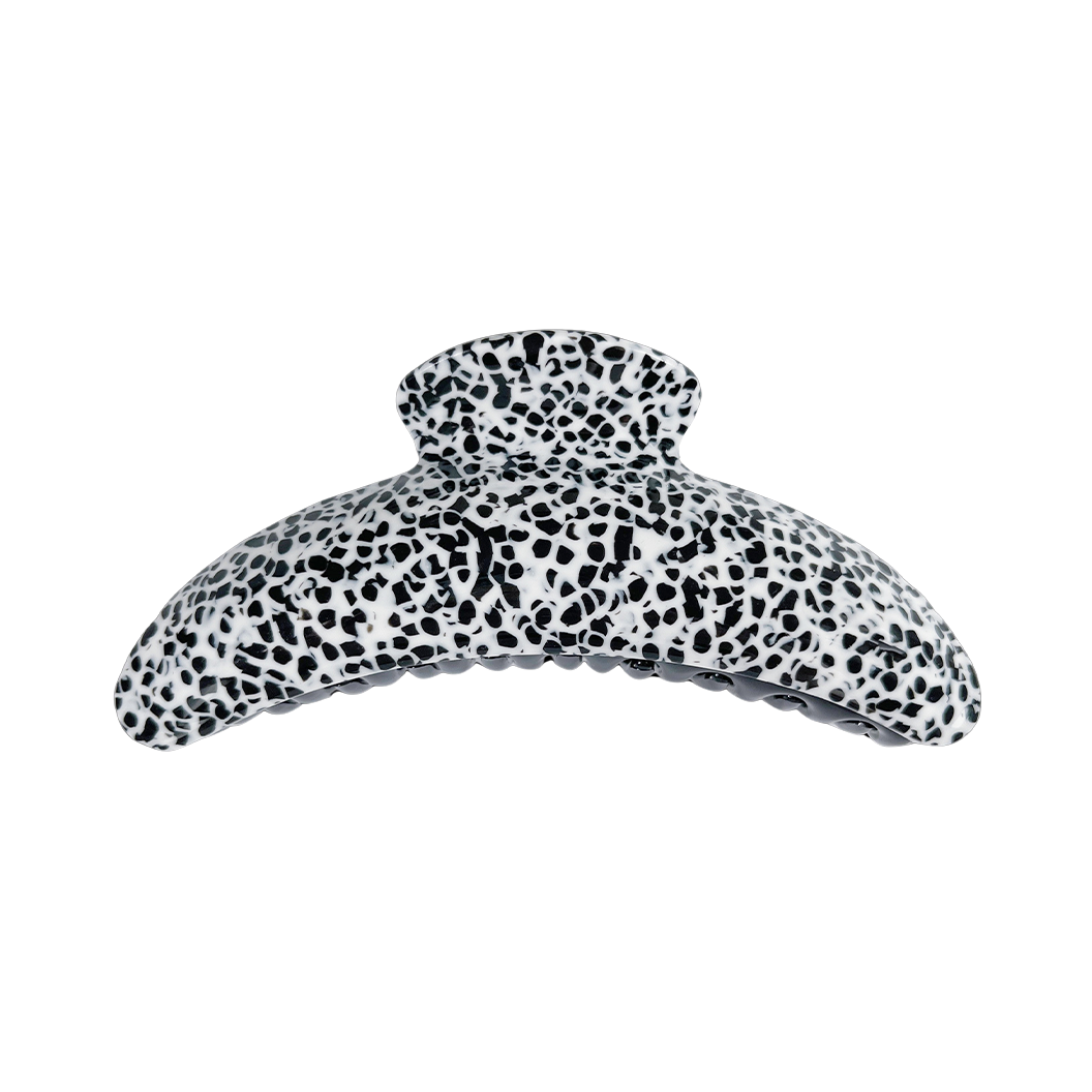Meet DEMI!  A large curved classic shape hair claw with double grip finish. The curved design and wider body makes it perfect for that all up look, even for thicker hair.  Each clip comes in a branded Tort pouch (colours change seasonally).  Size: 13cm  Colour: black and white Dalmatian-like pattern  Material: eco-resin