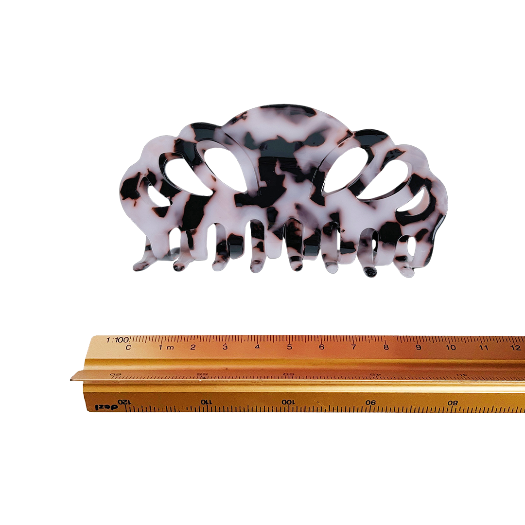 Meet ELLI!    A medium sized hair claw with scalloped edges and a strong grip. This claw works on all hair, including thick hair.  Each clip comes in a branded Tort pouch (colours change seasonally).  Size: 10cm  Colour: cloudy white-lilac and black leopard-like pattern  Material: eco-resin