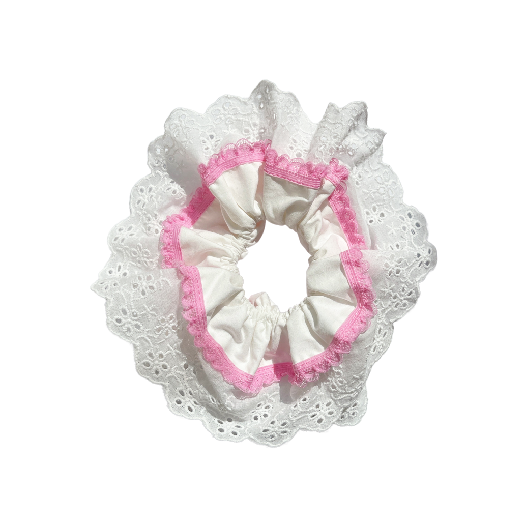 Meet GILA!  A scrunchie big enough to hold all hair. Four layers of broderie anglaise and cotton centre make it perfect for an all up look or for securing a bun on thicker hair. Try it tied twice round on finer hair.  Each scrunchie comes with a pink ribbon tag on which can be used as a gift tag.  Size: approx 18cm  Colour: White lace with a taffy pink lace accent  Material: Cotton
