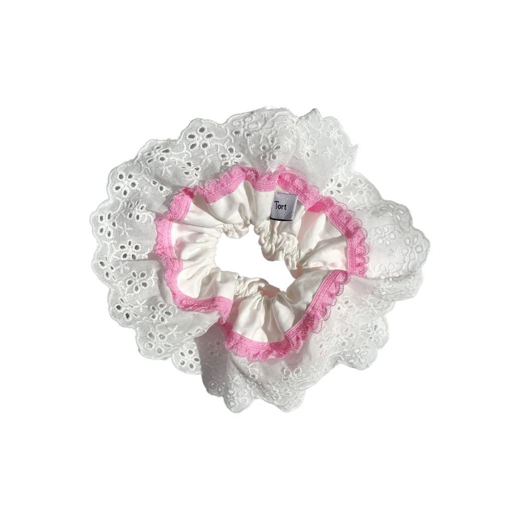 Meet GILA!  A scrunchie big enough to hold all hair. Four layers of broderie anglaise and cotton centre make it perfect for an all up look or for securing a bun on thicker hair. Try it tied twice round on finer hair.  Each scrunchie comes with a pink ribbon tag on which can be used as a gift tag.  Size: approx 18cm  Colour: White lace with a taffy pink lace accent  Material: Cotton
