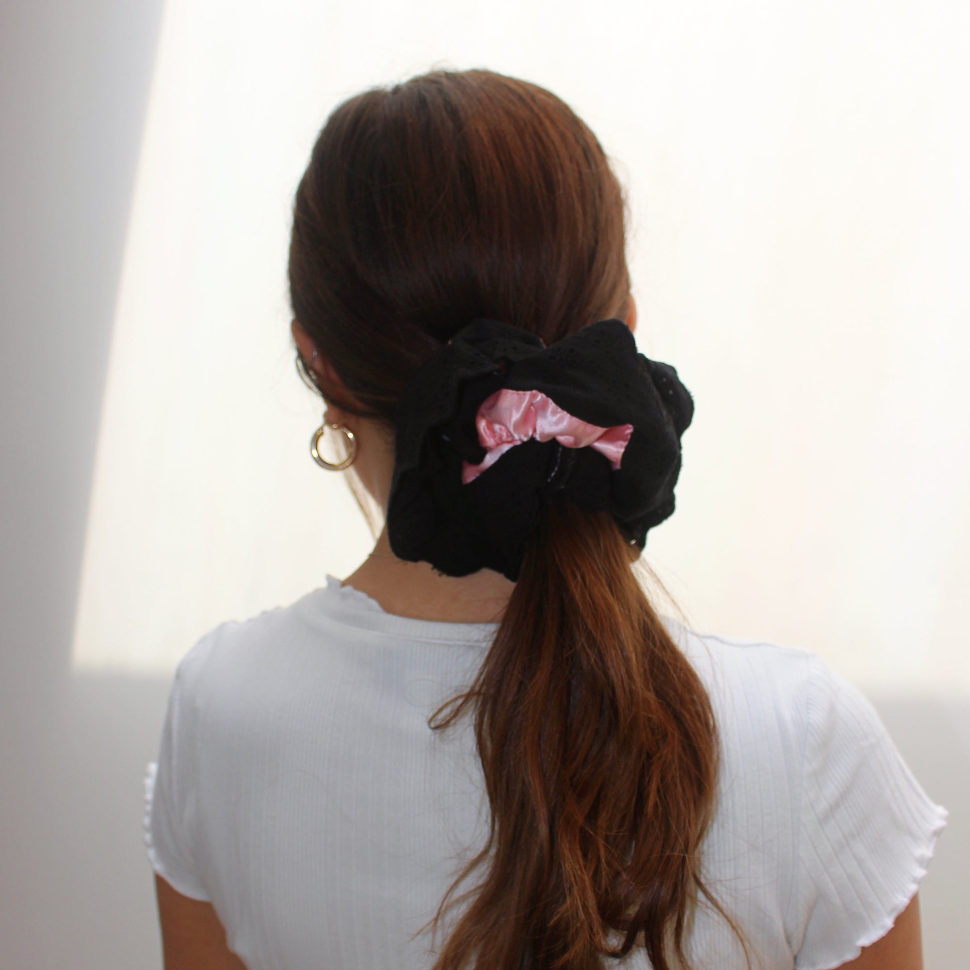 Meet LOLA!  A scrunchie big enough to hold all hair. Two layers of broderie anglaise makes it perfect for an all up look on both fine and thicker hair, or great for securing a bun. The silky centre is kinder to the hair, especially if being worn overnight.  Each scrunchie comes with a pink ribbon tag on which can be used as a gift tag.  Size: approx 18cm  Colour: black lace with a blush pink silk centre  Material: Cotton and Satin