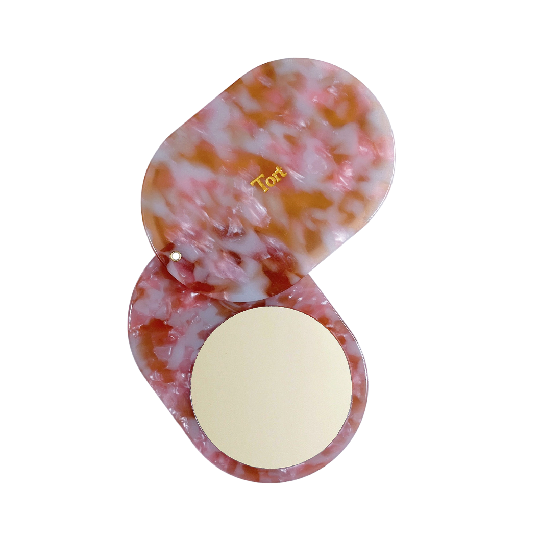Meet JAYA!  A compact mirror is a handbag essential. Made from smooth, hand-poured eco-resin, the JAYA mirror is super cute with added protection and cleanliness through a sliding mechanism.  Each mirror comes in a branded Tort pouch (colours change seasonally).  Size: 10.5cm  Colour: light pink, brown and cloudy white  Material: eco-resin