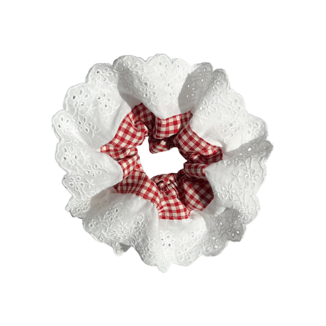 Meet LOLA!  A scrunchie big enough to hold all hair. Two layers of broderie anglaise makes it perfect for an all up look on both fine and thicker hair, or great for securing a bun.  Each scrunchie comes with a pink ribbon tag on which can be used as a gift tag.  Size: approx 18cm  Colour: white lace with a cherry red gingham centre  Material: Cotton