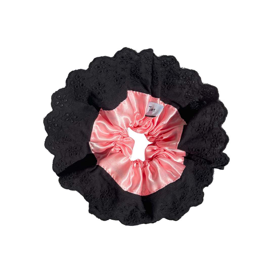 Meet LOLA!  A scrunchie big enough to hold all hair. Two layers of broderie anglaise makes it perfect for an all up look on both fine and thicker hair, or great for securing a bun. The silky centre is kinder to the hair, especially if being worn overnight.  Each scrunchie comes with a pink ribbon tag on which can be used as a gift tag.  Size: approx 18cm  Colour: black lace with a blush pink silk centre  Material: Cotton and Satin