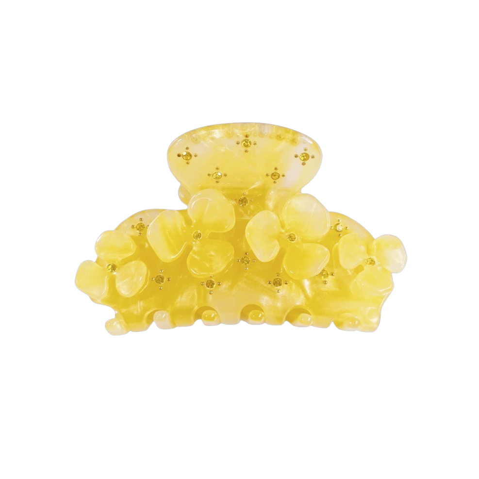 Meet JOAN!  A medium sized silhouette claw with flower and rhinestone details. The medium size makes it very easy to use and perfect for an all up look or securing a bun. For shorter hair it can be used for an all up look. It looks as cute off as on the hair.  Each clip comes in a branded Tort pouch (colours change seasonally).  Size: 7.5cm  Colour: pale yellow with pearlescent yellow daisies and rhinestone accents  Material: eco-resin