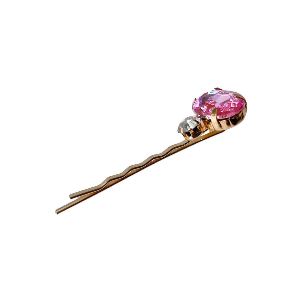 Meet BETH!  An oval emerald cut next to a smaller clear crystal design, on a gold-brass hair slide. The smaller hair slide ensures a secure fit and hold on most hair types, even fine hair.  Each clip comes in a branded Tort pouch (colours change seasonally).  Size: 6cm  Colour: sapphire pink and crystal on a gold-brass hair slide  Material: hand crafted glass beads