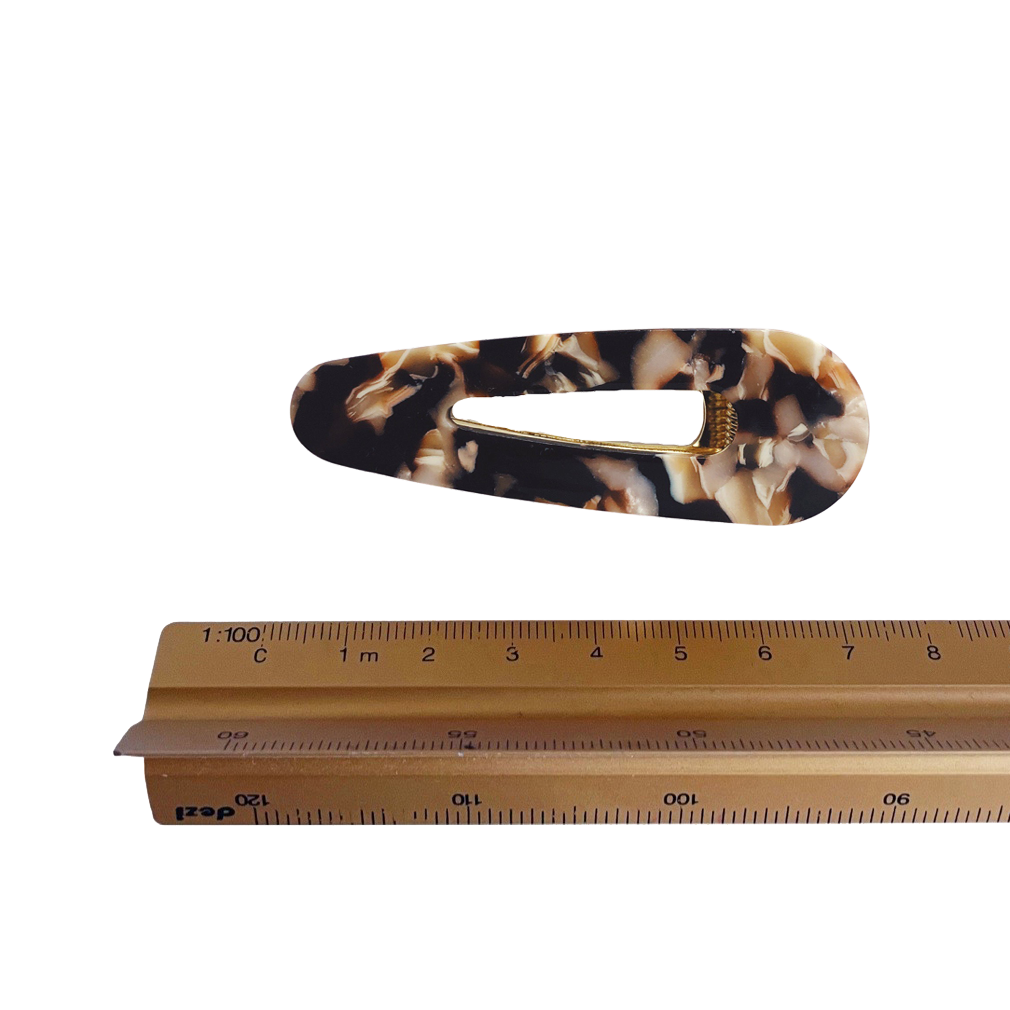 Meet CORA!  Our OG clip, a rounded-edge barrette featuring a gold hinge fastening and a teeth effect grip for a sturdy and reliable hold. Great for keeping hair in place or simply clipping back your grown out fringe.  Each clip comes in a branded Tort pouch (colours change seasonally).  Size: 7cm  Colour: marbled brown, beige and ivory  Material: eco-resin