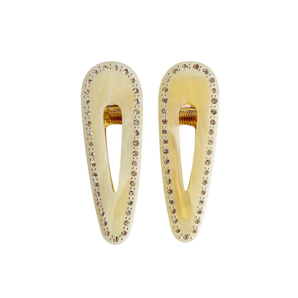 Meet CORA!  Our OG clip, a rounded-edge barrette featuring rhinestones and gold hinge fastening with a teeth effect grip for a sturdy and reliable hold. Great for keeping hair in place or simply clipping back your grown out fringe.  Each clip comes in a branded Tort pouch (colours change seasonally).  Size: 7cm  Colour: pale yellow with yellow rhinestone accents  Material: eco-resin