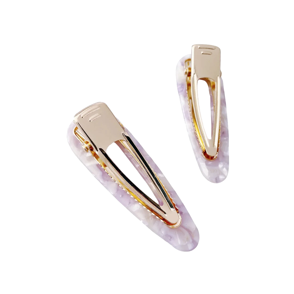 Meet CORA!  Our OG clip, a rounded-edge barrette featuring rhinestones and gold hinge fastening with a teeth effect grip for a sturdy and reliable hold. Great for keeping hair in place or simply clipping back your grown out fringe.  Each clip comes in a branded Tort pouch (colours change seasonally).  Size: 7cm  Colour: ivory and lilac tie-dye effect with silver rhinestone accents  Material: eco-resin 
