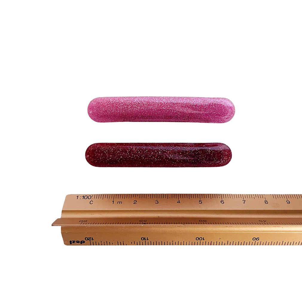 Meet EDIE!  A pair of classic long clips with round edges and a French barrette clasp. The secure clasp on the back ensures hair is held in place.   Each clip comes in a branded Tort pouch (colours change seasonally).  Size: 7cm  Colour: ruby red and pink glitter  Material: eco-resin
