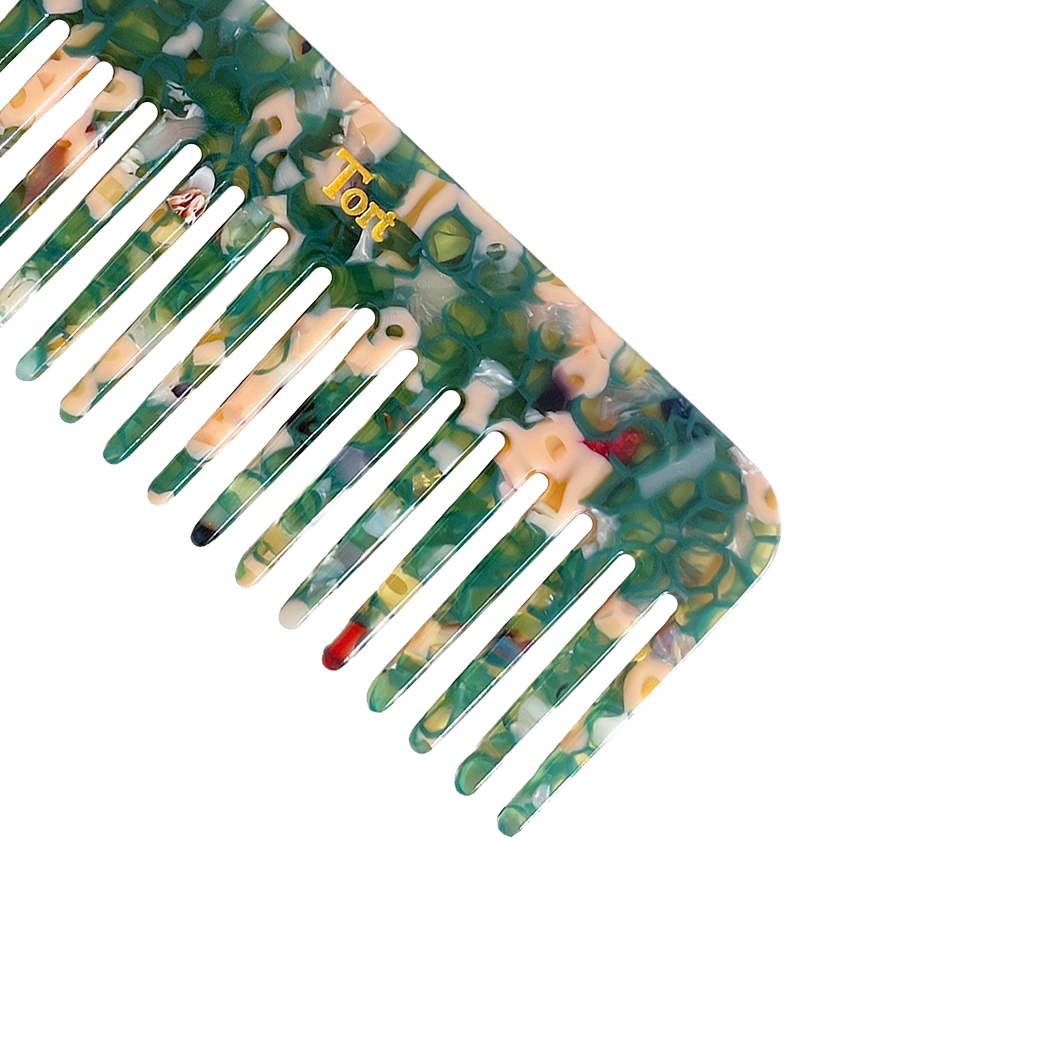 Meet ELVA!  A sturdy round-edged rectangle comb made from eco-resin. Designed with medium positioned rounded teeth so that hair retains texture and strength. Glides through wet or dry hair to untangle or tease after curling with tongs or straighteners, while preventing breakage, split ends and frizz.   Each comb comes in a branded Tort pouch (colours change seasonally).  Size: 15cm  Colour: translucent green and peachy-pink  Material: eco-resin  Combs are non-refundable for hygiene reasons.