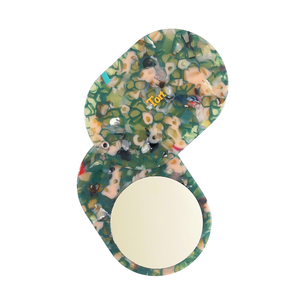 Meet JAYA!  A compact mirror is a handbag essential. Made from smooth, hand-poured eco-resin, the JAYA mirror is super cute with added protection and cleanliness through a sliding mechanism.  Each mirror comes in a branded Tort pouch (colours change seasonally).  Size: 10.5cm  Colour: marbled translucent green and peachy-pink  Material: eco-resin