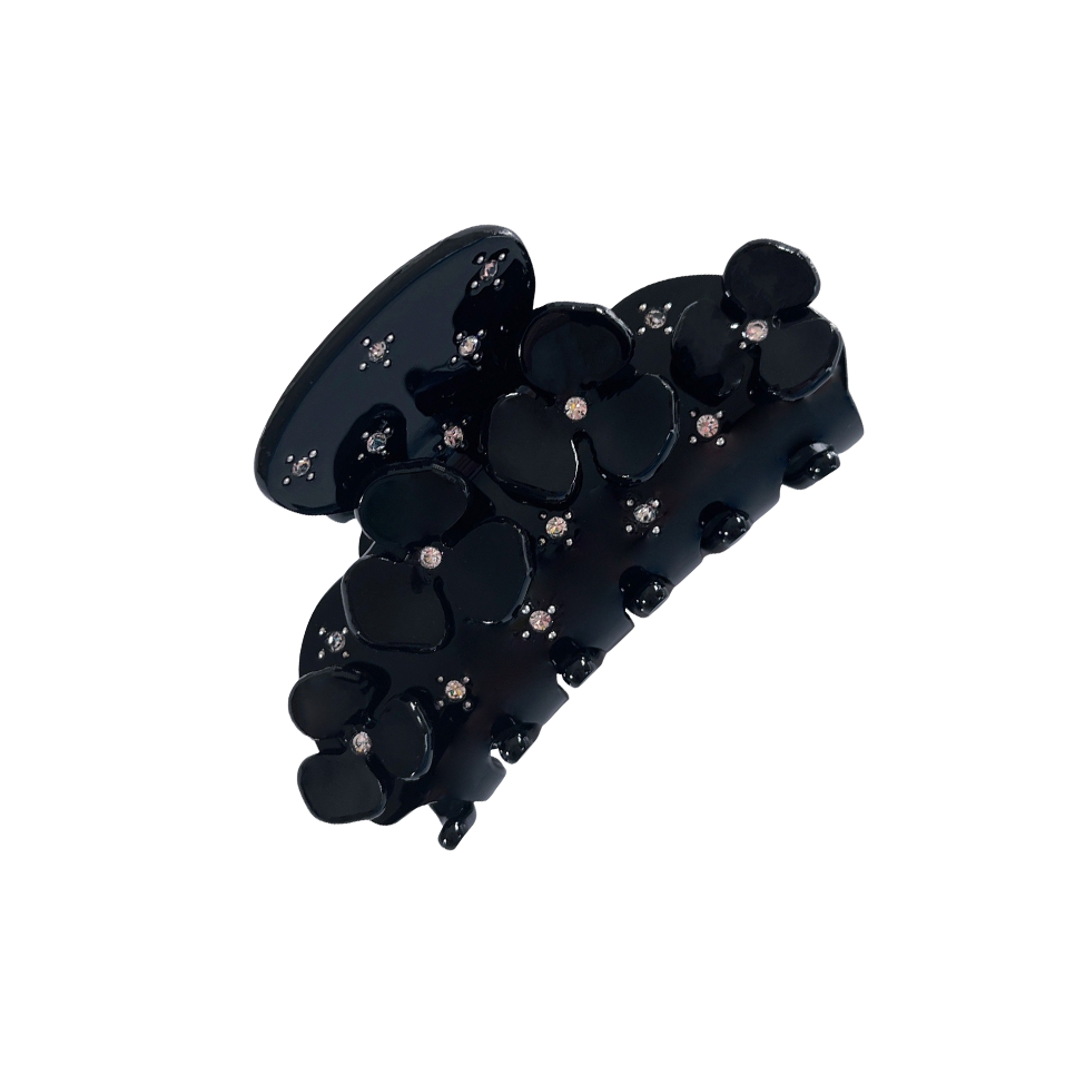 Meet JOAN!  A medium sized silhouette claw with flower and rhinestone details. The medium size makes it very easy to use and perfect for an all up look or securing a bun. For shorter hair it can be used for an all up look. It looks as cute off as on the hair.  Each clip comes in a branded Tort pouch (colours change seasonally).  Size: 7.5cm  Colour: jet black with crystal rhinestone accents  Material: eco-resin