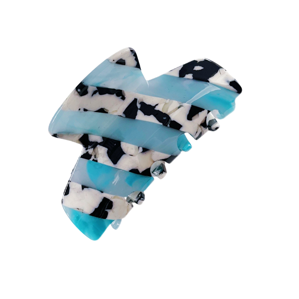 Meet LORA!  A medium sized silhouette claw in our signature stripes. Two resin patterns are merged together to create a colour combinations of dreams. The medium size makes it very easy to use and perfect for an all up look or securing a bun. For shorter hair it can be used for an all up look.  Each clip comes in a branded Tort pouch (colours change seasonally).  Size: 9cm  Colour: sky blue and cow print stripe  Material: eco-resin