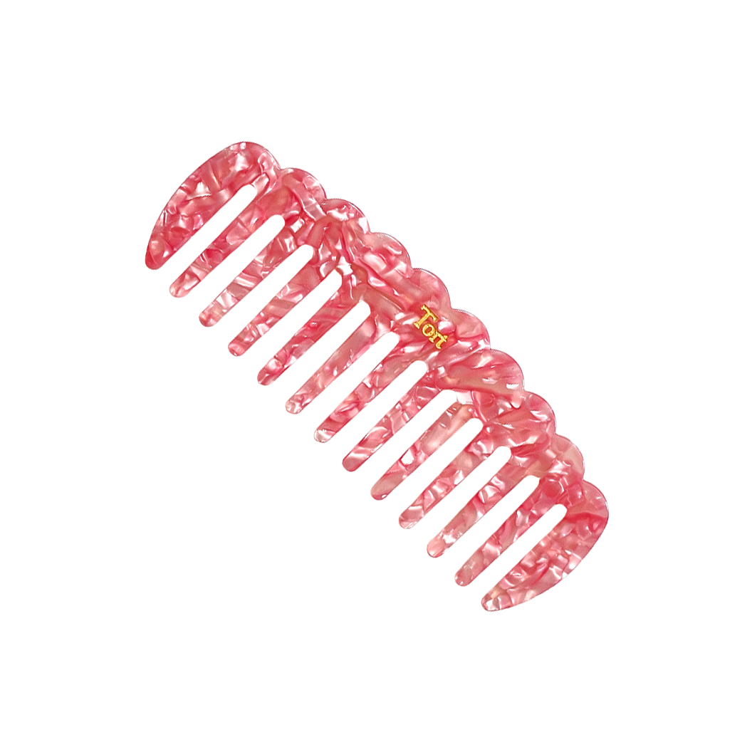 Meet LUCY!  A sturdy scallop edged comb make from eco-resin. Designed with widely positioned rounded teeth so that hair retains texture and strength. Glides through wet or dry hair to gently untangle or tease after curling with tongs or straighteners, while preventing breakage, split ends and frizz. Great for curly hair.  Each comb comes in a branded Tort pouch (colours change seasonally).  Size: 15cm  Colour: pearlised light pink  Material: eco-resin  Combs are non-refundable for hygiene reasons. 