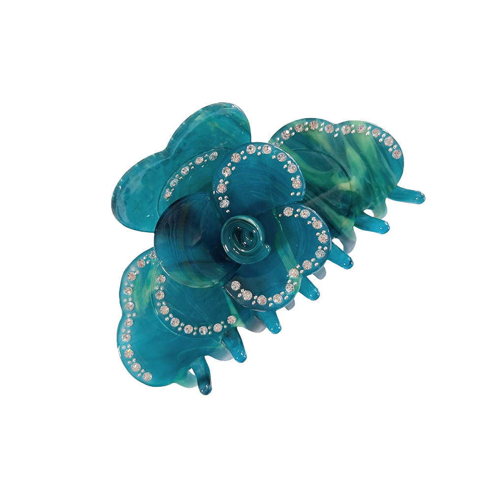 Meet SUZY!  A medium-large clip with flower-shaped detail and rhinestone detailing on each side. Best for half up-half-down looks on thicker hair, while it’s great styled, any-way on medium to fine hair.  Each clip comes in a branded Tort pouch (colours change seasonally).  Size: 9cm  Colour: petrol-blue and aqua with rhinestone accents and silver studs  Material: eco-resin 