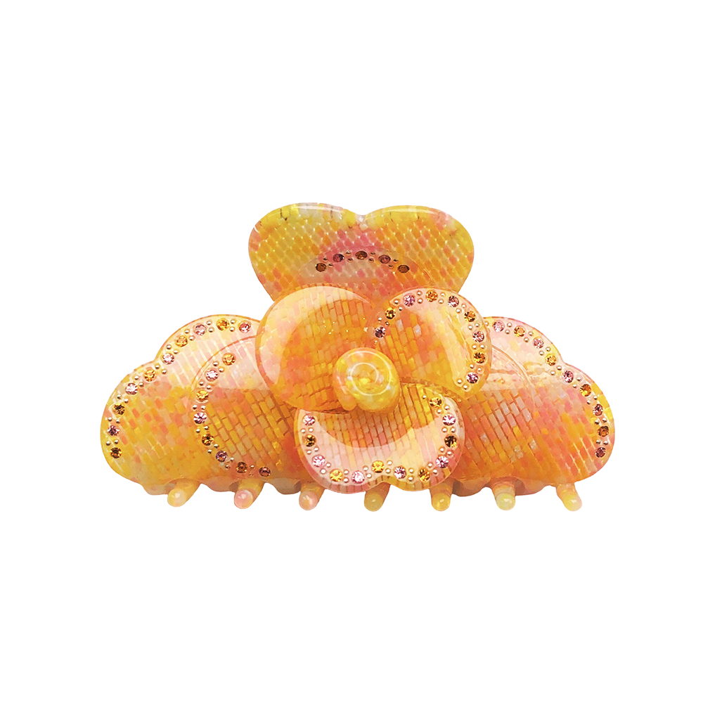 Meet SUZY!  A medium-large clip with flower-shaped detail and rhinestone detailing on each side. Best for half up-half-down looks on thicker hair, while it’s great styled, any-way on medium to fine hair.  Each clip comes in a branded Tort pouch (colours change seasonally).  Size: 9cm  Colour: pixelated yellow and pink ombre pattern with rhinestone accents and silver studs  Material: eco-resin 