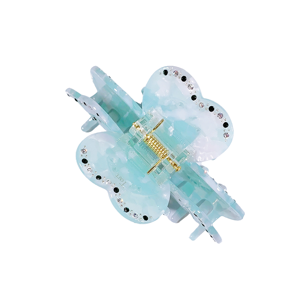 Meet SUZY!  A medium-large clip with flower-shaped detail and rhinestone detailing on each side. Best for half up-half-down looks on thicker hair, while it’s great styled, any-way on medium to fine hair.  Each clip comes in a branded Tort pouch (colours change seasonally).  Size: 9cm  Colour: ice pale blue with contrasting rhinestone accents and silver studs  Material: eco-resin