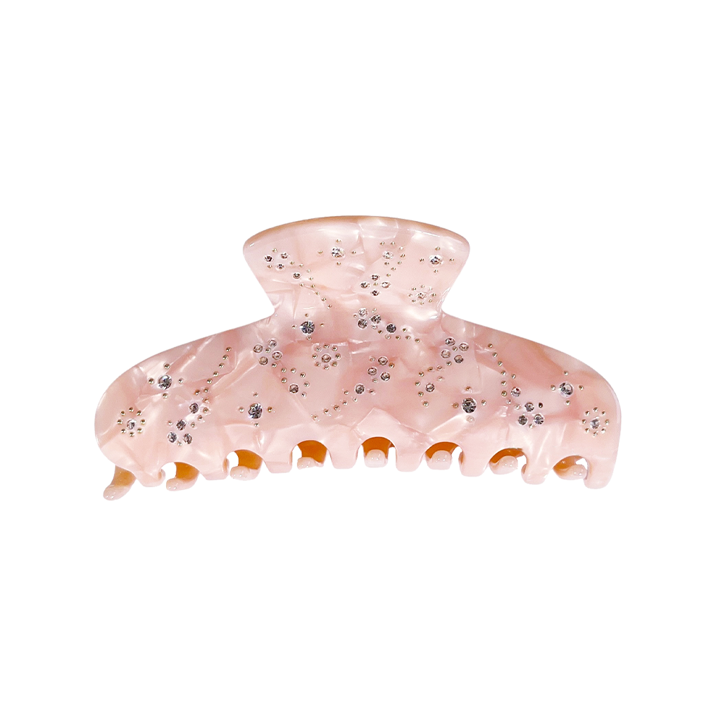 Meet YARA!  A medium-large slimmer silhouette shaped hair claw with rhinestone and delicate stud detail. The shorter close together teeth allow for it to hold even fine hair in place.  Each clip comes in a branded Tort pouch (colours change seasonally).  Size: 10cm  Colour: blush pink with crystal jewels and silver studs  Material: eco-resin