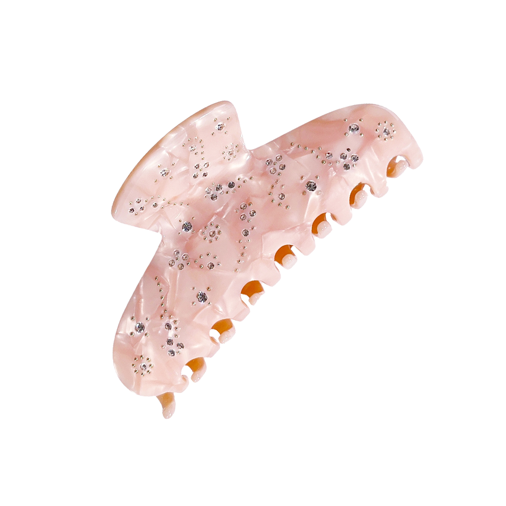 Meet YARA!  A medium-large slimmer silhouette shaped hair claw with rhinestone and delicate stud detail. The shorter close together teeth allow for it to hold even fine hair in place.  Each clip comes in a branded Tort pouch (colours change seasonally).  Size: 10cm  Colour: blush pink with crystal jewels and silver studs  Material: eco-resin