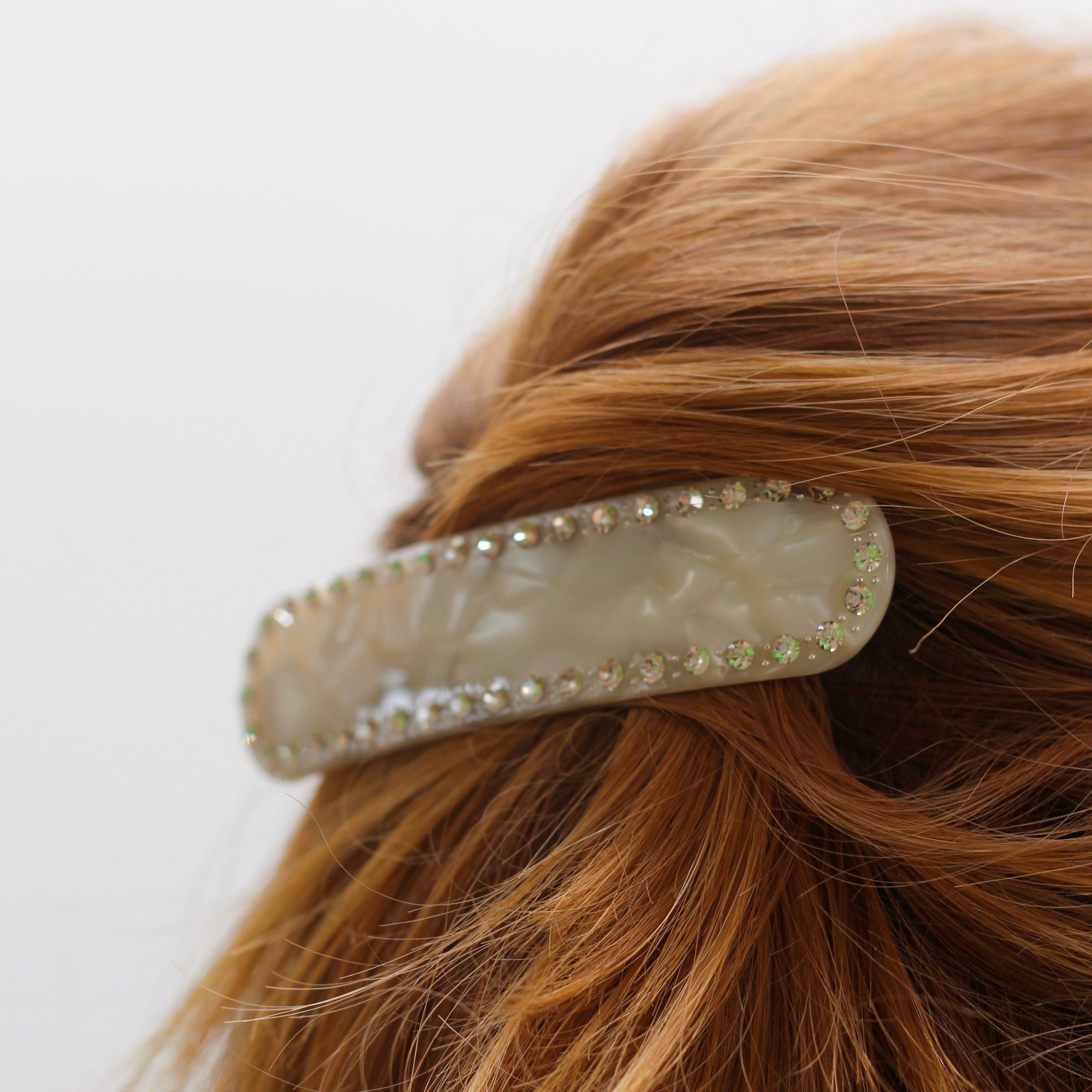 Meet ZADI XL!  A round edged rectangular hair clips with with jewelled detailing and French barrette clasp. Clips to the hair securely and holds well. We recommend using it as a feature clip at the back of the hair above a ponytail or to secure a half up look. Please note this is the larger version of the original ZADI clip in Ivory Jewel.  Each clip comes in a branded Tort pouch (colours change seasonally).  Size: 11.5cm  Colour: ivory pearl with silver crystal accents  Material: eco-resin