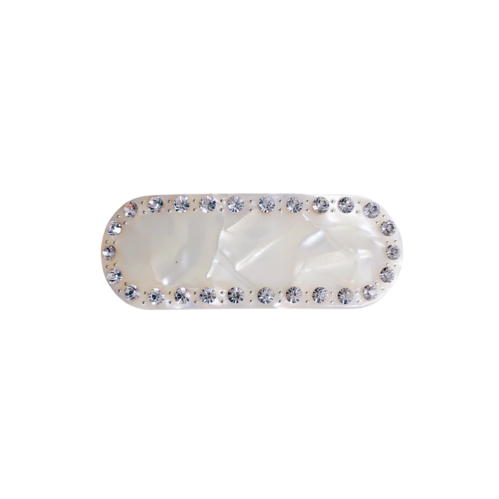 Meet ZADI!  A round edged rectangular hair clips with with jewelled detailing and French barrette clasp. Clips to the hair securely and holds well. We recommend using it as a feature clip at the back of the hair above a ponytail or to secure a half up look.  Each clip comes in a branded Tort pouch (colours change seasonally).  Size: 7cm  Colour: ivory pearl with silver crystal accents  Material: eco-resin