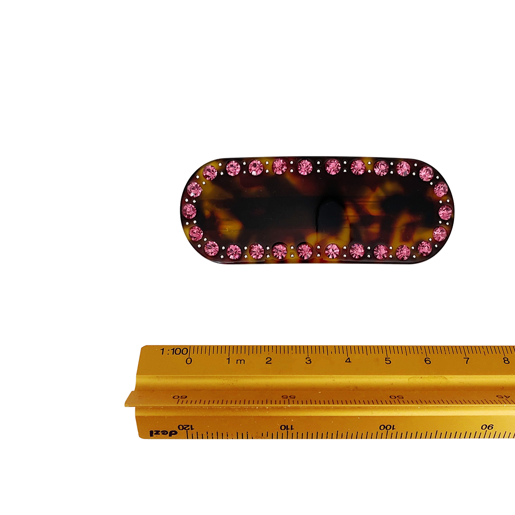 Meet ZADI!  A round edged rectangular hair clips with with jewelled detailing and French barrette clasp. Clips to the hair securely and holds well. We recommend using it as a feature clip at the back of the hair above a ponytail or to secure a half up look.  Each clip comes in a branded Tort pouch (colours change seasonally).  Size: 7cm  Colour: brown tortoiseshell with pink crystal accents  Material: eco-resin 